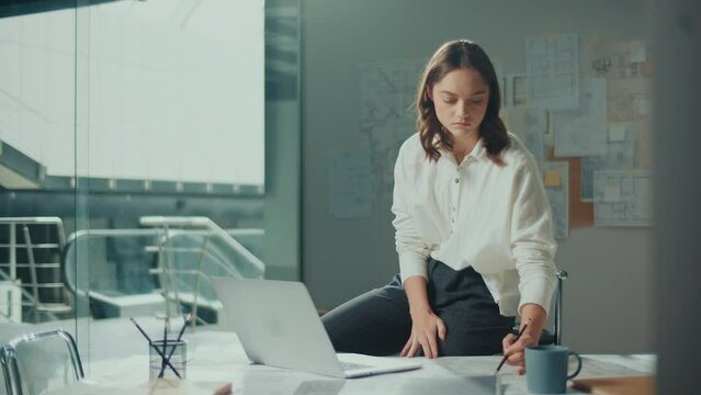 Confident Female Engineer is Typing on a Laptop Computer, Working Online on a New Project. Motivated Female Manager is Doing a New Project. Engineering and Creativity New Product Development