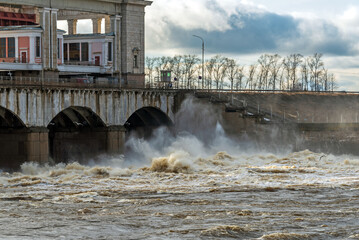 Discharge of water from the dam on the river during the spring flood.