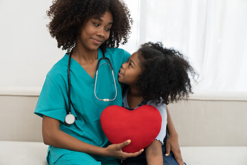 Young female doctor visit kid child girl patient in hospital. Young nurse taking care child girl...