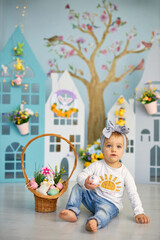 Obraz na płótnie Canvas Baby girl celebrate Easter. Funny happy kid in bunny ears playing on Easter egg hunt. Family home decoration, colorful Easter eggs and flowers. Home decoration and flowers