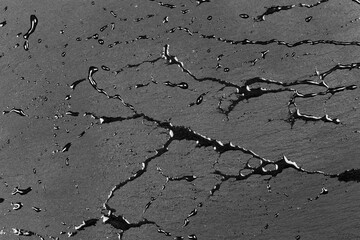 Water on dark flat stone surface