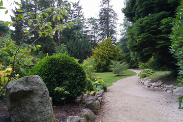 Winding path in Powerscourt Gardens, Co. Wicklow, Ireland, with many trees.