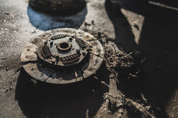 closeup shot of a broken clutch lying on the floor, repair shop concept. High quality photo