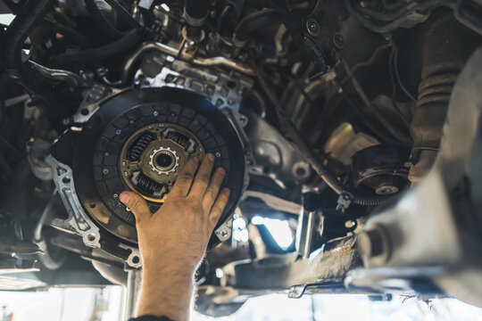 auto mechanic installing a new clutch kit for a car, closeup shot. High quality photo