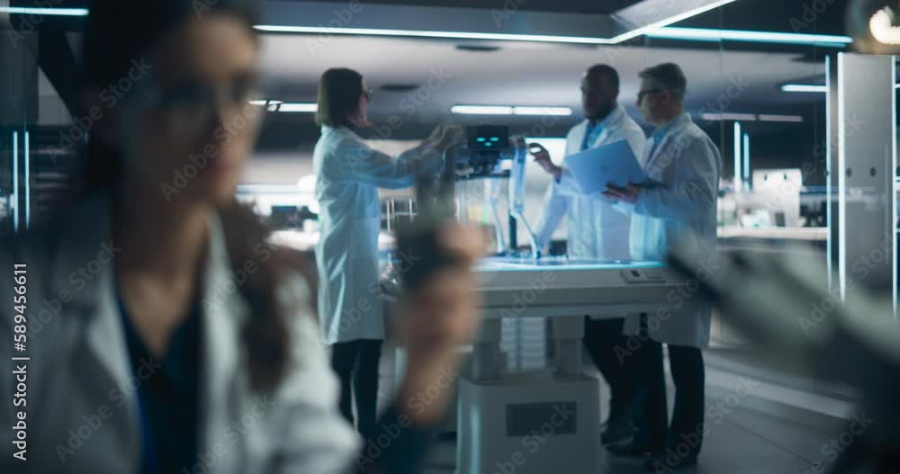 Aufkleber Female Scientist Using Screwdriver to Fix a Prosthetic Robotic Hand. Focus Switching to a Diverse Team of Industrial Specialists Working on Advanced Mobility Robot Dog with Artificial Intelligence