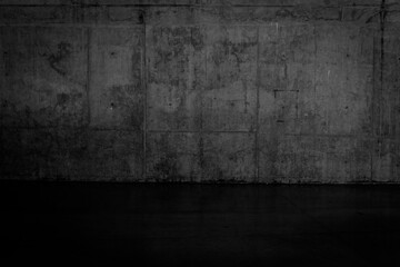 Grungy dark concrete wall and wet floor