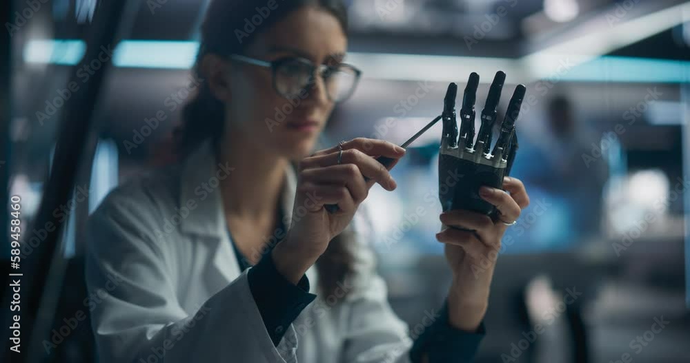 Poster Portrait of a Young Female Scientist Working in Technological Research and Development Company, Assembling an Innovative Bionic Prosthetic Hand. Engineer Working on Technology for Physically Impaired