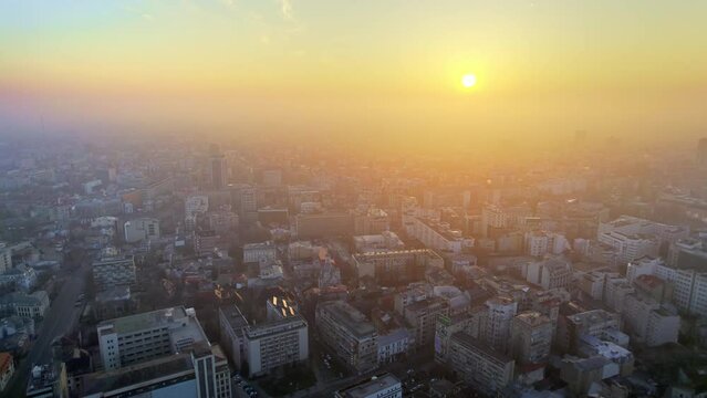 Aerial drone view of Bucharest at sunset, Romania. Multiple residential buildings, fog in the air