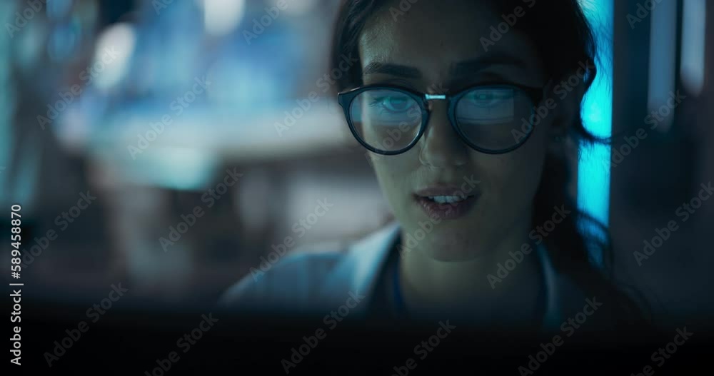 Poster portrait of beautiful multiethnic woman working on computer with the screen reflecting in her glasse