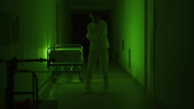 A mad male patient in straitjacket is going crazy in a mental hospital. Mentally ill man with psychic disorders and bipolar disease. Concept of paranoia or schizophrenia and madness or depression.