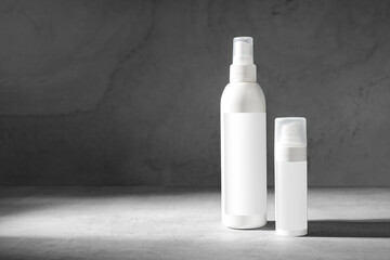 Natural beauty cosmetic product for skincare concept.Pure cosmetic in white dispensers on a grey marble background.