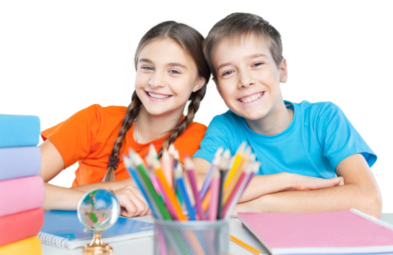 Happy children sitting by the table during lesson