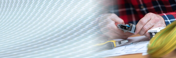 Electrician stripping a wire; panoramic banner