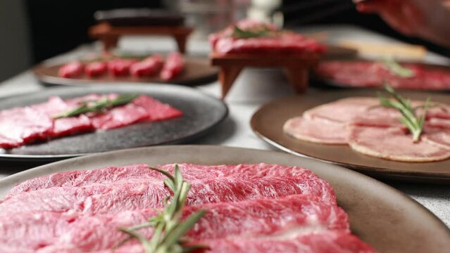 Slow motion VDO. Woman hand using chopsticks pinking up wagyu beef. Grilled japanese premium wagyu beef Sirloin steak
