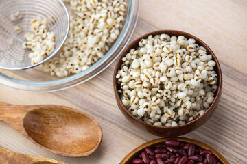 Hot Boiled Job’s Tears millet seed from boiler. White boiled Job’s Tears is highly nutritious cereal healthy fresh organic in salad dish.