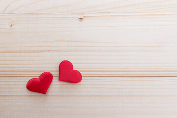 Red hearts on wooden background. Place for text, copy space.