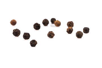 Black pepper seeds on white