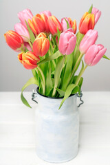 A bouquet of colorful tulips on the table.