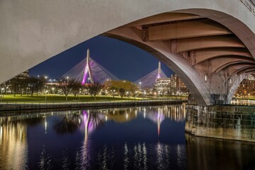 a bridge spans over a lake in the city at night