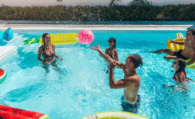 Group of friend play together in the swimming pool