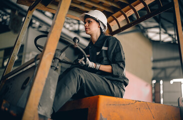 Fototapeta na wymiar A female robotic technician operates the folklift and schedules regular maintenance and repairs. A gender-neutral workplace in which all employees are honored and respected with low discrimination