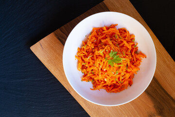 Food concept Homemade French carrot salad Lemon Dejon Mustard and honey on wooden board with copy space