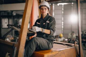 Fototapeta na wymiar A female robotic technician operates the folklift and schedules regular maintenance and repairs. A gender-neutral workplace in which all employees are honored and respected with low discrimination