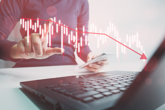 Investor analyze stock chart with laptop, businessman forecast and analysis graph in Bearish downtrend, economic slowdown, inflation crisis, loan interest rise, trade war finance, covid-19 impact.