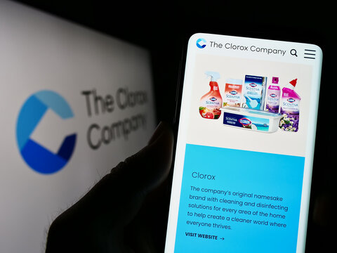 Stuttgart, Germany - 03-31-2023: Person holding cellphone with webpage of US chemicals manufacturer Clorox Company on screen in front of logo. Focus on center of phone display.