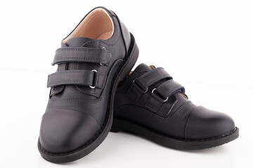 A pair of black leather shoes on a white background.
