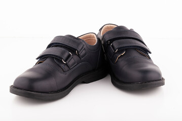 A pair of black leather shoes on a white background.