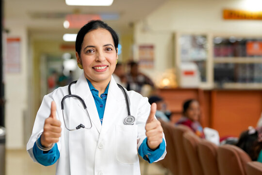 Indian female doctor showing thumps up at hospital.