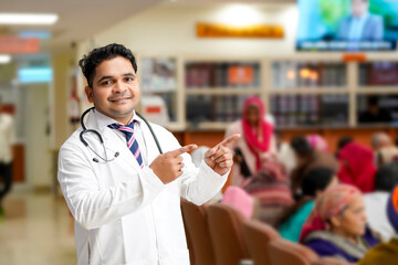 Indian male doctor smiling and giving expression at hospital.