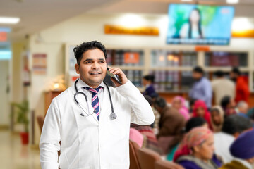 Doctor talking on smartphone at hospital.