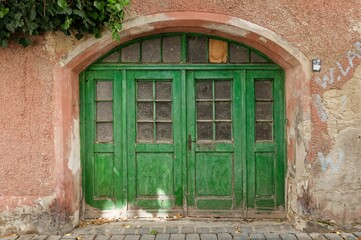 Fototapeta na wymiar Green door in an old building facade