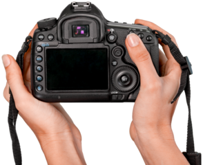 Hands holding modern camera isolated on white background