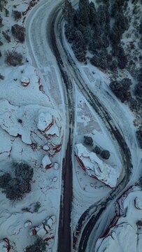 Aerial View Of Mountain Roads, And Rocky Structures Covered By Snow, On A Cold Winter Day