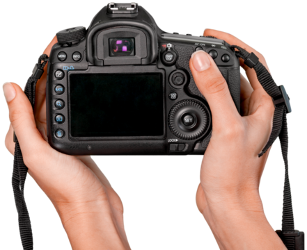 Hands holding modern camera isolated on white background