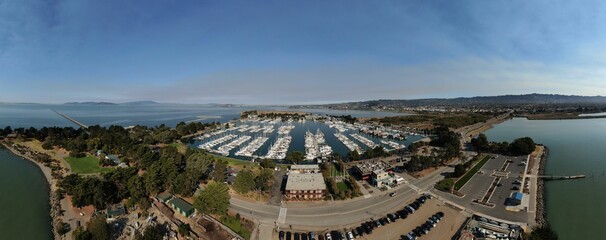 Panoramic drone shot of the Dana Point Harbor with mountains in the background in California, USA