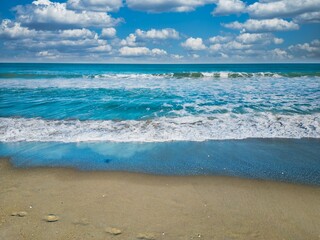 Fototapeta na wymiar Beach with its golden sand and crystal blue waters in Melbourne, Florida