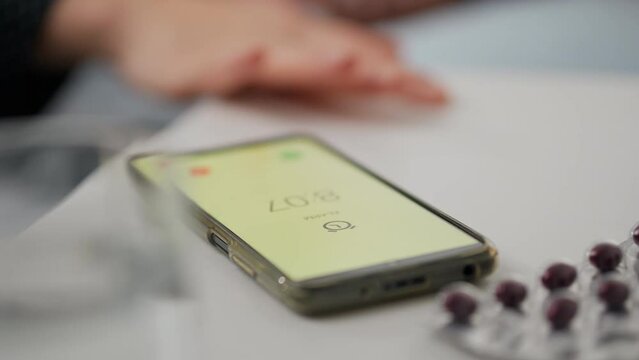 Morning, Responsible employee of the company Calmly Looking for a phone to turn off the alarm In his house, Close-up The worker Is in a sleepy state Wakes up early in the morning, lifestyle
