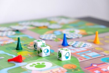 Board games for the home. Green, blue, yellow and red chips and dice on board games for children. 