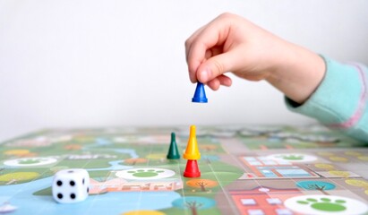 Board games for the home. Green, blue, yellow and red chips and dice on board games for children. 