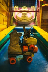 Vertical shot of a pair of old and dirty roller skates at a skating ring