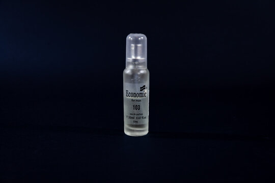 PARACIN, SERBIA - MARCH 2, 2023: Eau De Parfum Economic perfume on a black background. Economic Parfemi is a serbian brand of cosmetics specialized in fragrance, cologne, perfumes.
