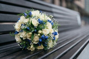 Closeup shot of the bride's bouquet with white and blue flowers