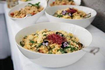 Delicious dish served in a white bowl on a white table.
