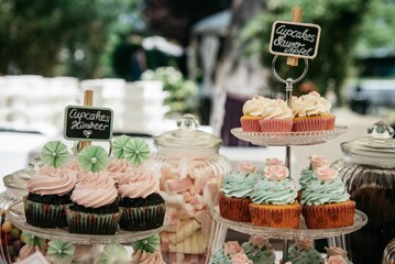 Cupcakes with whipped cream, decorations for a wedding ceremony.
