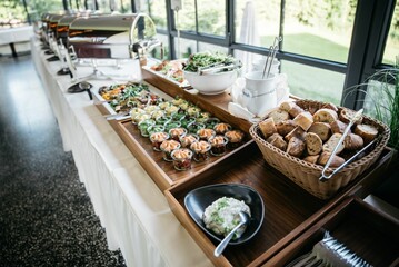 Table filled with salads desserts and bread indoors