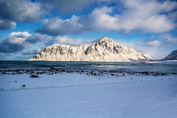 Snowy landscape and mountain on arctic Skagsanden beach